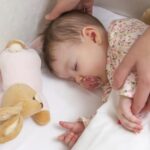 466488113-baby-in-crib-facc871d96