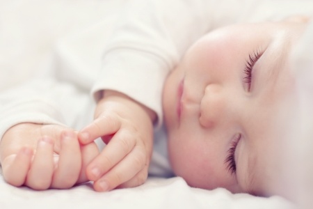 23843155 - close-up portrait of a beautiful sleeping baby on white